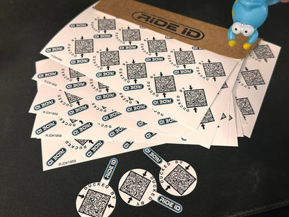 RideID Duck Tag sheets with a kraft envelope, loose Duck Tags, and a rubber duck